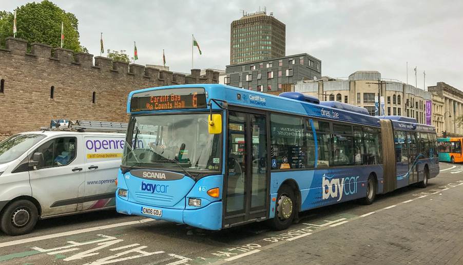 A blue bus on the street
Description automatically generated