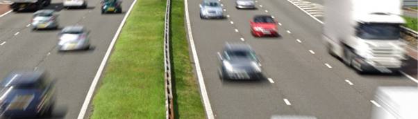 A close up of a car going down the highway

Description automatically generated