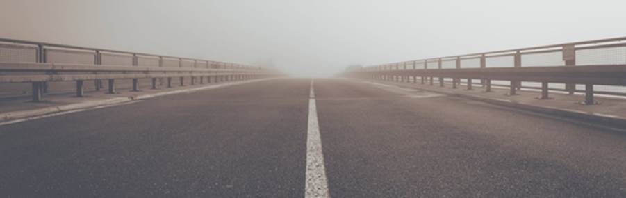 A road with a white line on it
Description automatically generated